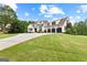 Wide front yard view of a two-story home with a three-car garage and a concrete driveway at 215 Sheridan Ln, Peachtree City, GA 30269