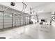 Expansive garage featuring three bays, epoxy flooring, and overhead storage, providing plenty of room at 215 Sheridan Ln, Peachtree City, GA 30269