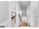 Hallway leading downstairs, next to a doorway, with neutral carpet and a wooden handrail at 215 Sheridan Ln, Peachtree City, GA 30269