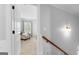Upstairs hallway adjacent to a bedroom, features neutral walls and carpet, and a view into the bedroom at 215 Sheridan Ln, Peachtree City, GA 30269