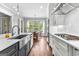 Bright kitchen featuring stainless steel appliances, marble countertops and a view into the dining area at 215 Sheridan Ln, Peachtree City, GA 30269