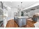 Bright kitchen with stainless steel appliances and center island with an open floor plan into the living room at 215 Sheridan Ln, Peachtree City, GA 30269
