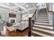 Cozy living room with hardwood floors, a fireplace, and a staircase at 215 Sheridan Ln, Peachtree City, GA 30269