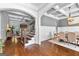 Open-concept living room with hardwood floors, coffered ceilings, and a staircase at 215 Sheridan Ln, Peachtree City, GA 30269