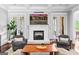 Living room with a fireplace, French doors, and neutral tones for a relaxing atmosphere at 215 Sheridan Ln, Peachtree City, GA 30269