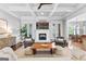 Cozy living room showcases fireplace, coffered ceiling, and ample seating with stylish decor at 215 Sheridan Ln, Peachtree City, GA 30269