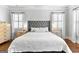 Beautiful main bedroom features a large, upholstered headboard and hardwood floors at 215 Sheridan Ln, Peachtree City, GA 30269