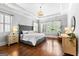 Spacious main bedroom featuring trey ceilings, hardwood floors and lots of natural light at 215 Sheridan Ln, Peachtree City, GA 30269