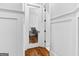 Hallway view of a home office with a glass door and hardwood floors at 215 Sheridan Ln, Peachtree City, GA 30269
