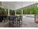 Covered outdoor dining area featuring a built-in grill and a view of the backyard swimming pool at 215 Sheridan Ln, Peachtree City, GA 30269