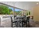 View of the outdoor dining area with a pool in the background and string lights overhead at 215 Sheridan Ln, Peachtree City, GA 30269