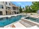 Backyard swimming pool and jacuzzi with an outdoor living area and a screened-in porch at 215 Sheridan Ln, Peachtree City, GA 30269