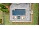 Aerial view of backyard pool, featuring lounge chairs, hot tub, and well manicured garden beds at 215 Sheridan Ln, Peachtree City, GA 30269