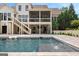 Back exterior of the house overlooking a large pool and lounge area at 215 Sheridan Ln, Peachtree City, GA 30269