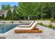 Relaxing lounge area with chairs and umbrella overlooking the large pool at 215 Sheridan Ln, Peachtree City, GA 30269