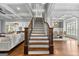 Grand staircase with dark wood trim and iron spindles, leading to the upper level of the home at 215 Sheridan Ln, Peachtree City, GA 30269