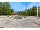 Swimming pool with in-pool lounge chairs and a small waterfall feature in a backyard setting at 215 Sheridan Ln, Peachtree City, GA 30269