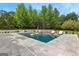 Swimming pool with in-pool lounge chairs and a small waterfall feature in a backyard setting at 215 Sheridan Ln, Peachtree City, GA 30269