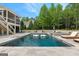 Swimming pool and spa with lounge chairs and lush green landscaping at 215 Sheridan Ln, Peachtree City, GA 30269