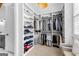 Bright walk-in closet features custom shelves and carpet floors with space for seating and storage at 215 Sheridan Ln, Peachtree City, GA 30269