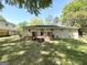 Spacious backyard featuring a wooden deck, lush greenery, and mature trees perfect for outdoor relaxation and entertainment at 6507 Jackie Ln, Austell, GA 30106
