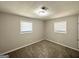 Cozy bedroom featuring two windows, neutral walls, and carpet flooring providing a serene and comfortable space at 6507 Jackie Ln, Austell, GA 30106