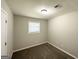 Simple bedroom with carpeted floors and natural light from the window at 6507 Jackie Ln, Austell, GA 30106