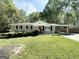 Ranch-style home with a carport and a well-manicured lawn at 6507 Jackie Ln, Austell, GA 30106