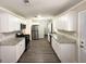 Renovated kitchen with white cabinets, granite countertops, and stainless steel appliances at 6507 Jackie Ln, Austell, GA 30106