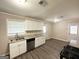 Bright kitchen with white cabinetry, granite countertops and stainless steel dishwasher at 6507 Jackie Ln, Austell, GA 30106