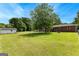 Large backyard with green grass and outbuilding with brick home in the background at 270 Lake Cir, Fayetteville, GA 30215