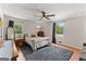 Cozy bedroom featuring neutral tones, hardwood floors, ceiling fan, and ample natural light at 270 Lake Cir, Fayetteville, GA 30215