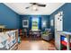A bedroom featuring a crib, soft chair, ceiling fan, and toys near a large window at 270 Lake Cir, Fayetteville, GA 30215