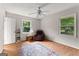Cozy bedroom with hardwood floors, ceiling fan, and windows offering natural light at 270 Lake Cir, Fayetteville, GA 30215