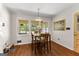 Dining nook featuring warm lighting, hardwood floors, and large windows open to kitchen at 270 Lake Cir, Fayetteville, GA 30215