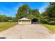 Detached garage with a concrete driveway and car port at 270 Lake Cir, Fayetteville, GA 30215