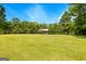 View of gazebo situated at the edge of lawn and a calm body of water, surrounded by trees at 270 Lake Cir, Fayetteville, GA 30215