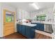 Charming kitchen with blue lower cabinets, white upper cabinets, white countertops and stainless steel appliances at 270 Lake Cir, Fayetteville, GA 30215