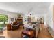 Spacious living room featuring hardwood floors, a brick fireplace, and large windows at 270 Lake Cir, Fayetteville, GA 30215