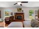 Cozy living room with a brick fireplace, hardwood floors, and comfortable seating at 270 Lake Cir, Fayetteville, GA 30215