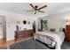 A calming main bedroom with a ceiling fan, a comfy-looking bed, and a dresser with decorations in natural light at 270 Lake Cir, Fayetteville, GA 30215