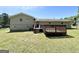 Backyard view of the home shows the large back deck, back door, and grassy yard at 5906 Pine Hurst Way, Douglasville, GA 30135
