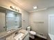 Well-lit bathroom featuring granite countertops and a shower-tub combination at 5906 Pine Hurst Way, Douglasville, GA 30135