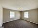 Bright bedroom featuring two windows, neutral walls, and plush carpeting at 5906 Pine Hurst Way, Douglasville, GA 30135