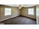 Comfortable bedroom featuring two windows, ceiling fan, and neutral colored walls at 5906 Pine Hurst Way, Douglasville, GA 30135