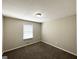 Cozy bedroom with neutral walls, plush carpeting, and a bright window at 5906 Pine Hurst Way, Douglasville, GA 30135