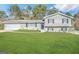 Charming split-level home with gray brick, mature trees and an expansive green lawn at 5906 Pine Hurst Way, Douglasville, GA 30135