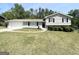Charming split-level home with gray brick, mature trees and an expansive green lawn at 5906 Pine Hurst Way, Douglasville, GA 30135