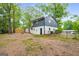 A spacious backyard shows the home's exterior with a modern two-story design and fenced perimeter at 410 Queen Aliese Ln, Jonesboro, GA 30236