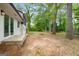 Spacious backyard with mature trees and level ground offers plenty of space to enjoy at 410 Queen Aliese Ln, Jonesboro, GA 30236